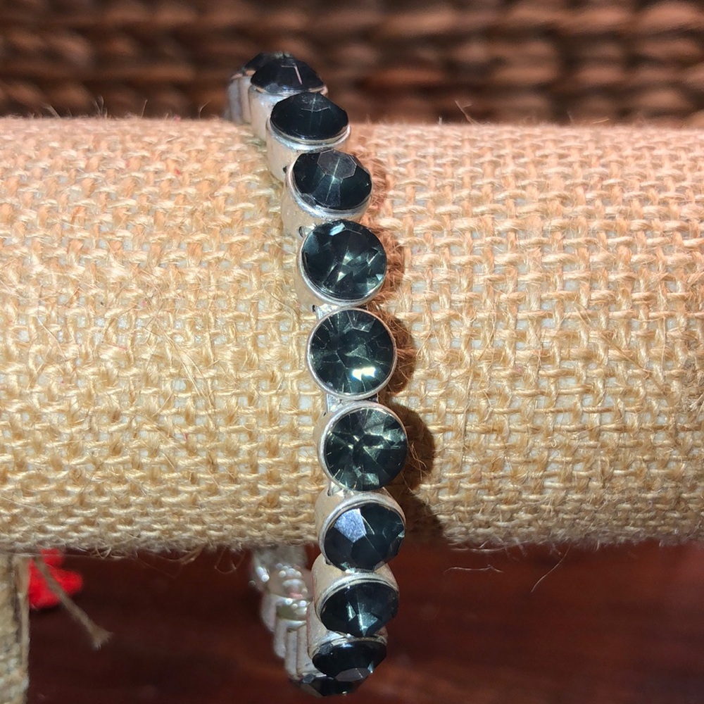 Silver bangle with Smokey stones